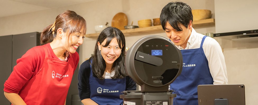 写真：自動調理鍋オートクッカービストロNF-AC1000を見ている川島さんと宮松さんと小西さん