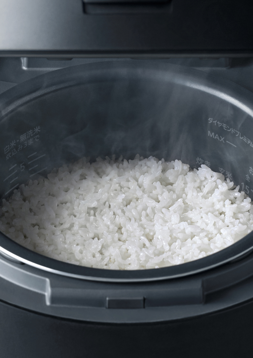 お米が炊きあがり、炊飯器の蓋を開けている画像です。