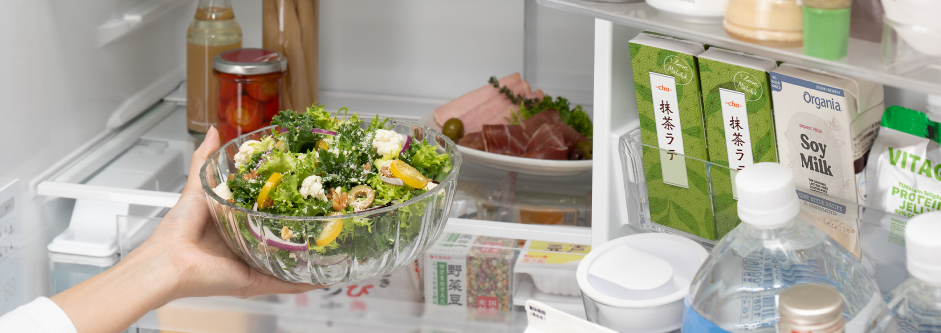 器に入れたサラダをラップなしで冷蔵庫に入れようとするイメージ