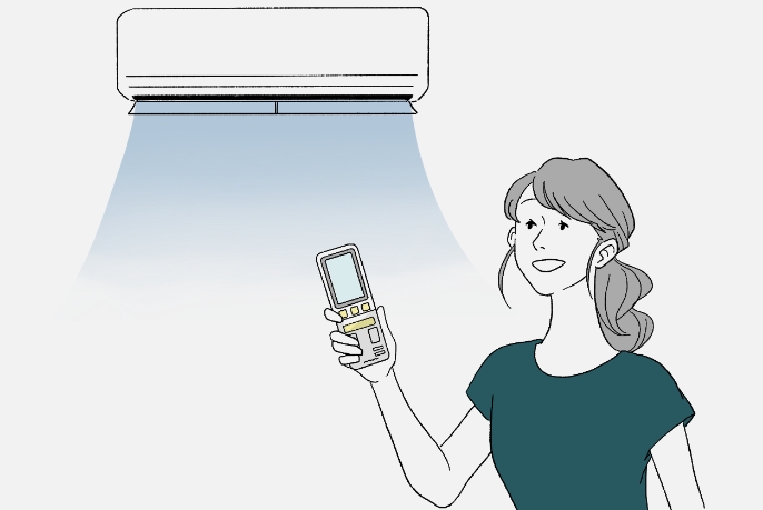 リモコンを持った女性がエアコンからの冷たい風を感じている画像です。