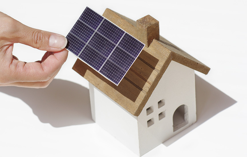 写真：家の屋根にソーラーパネルを取り付けるイメージ