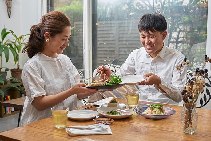 男性と女性が食卓でご飯を食べている様子