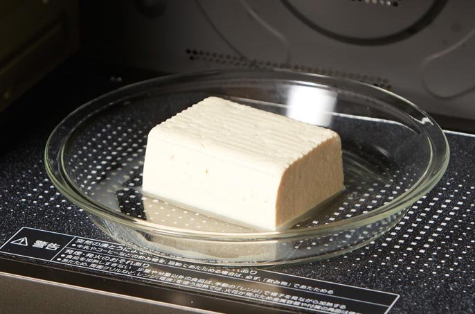 写真：豆腐を電子レンジに入れているイメージ