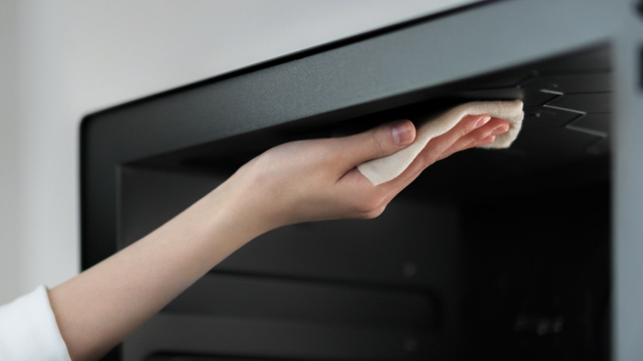 電子レンジ内を掃除しているイメージの写真