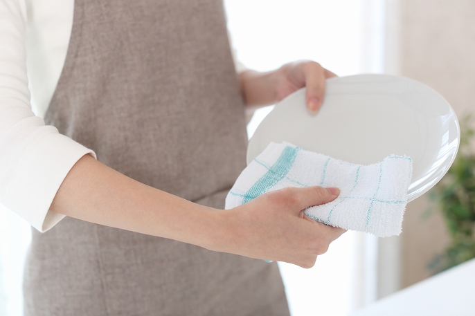 写真：食器を布巾で拭いている様子