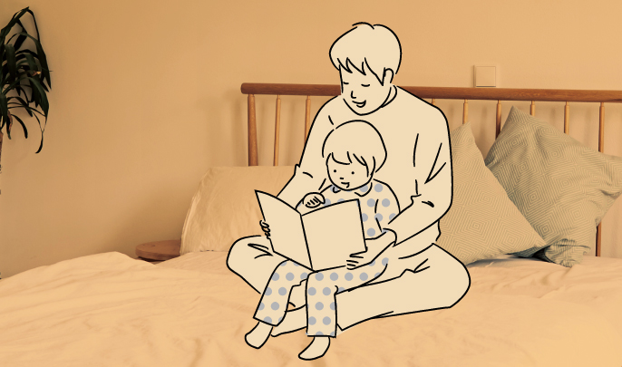 イメージ：落ち着いた灯の下で、父親が子どもに本を読んでいる様子
