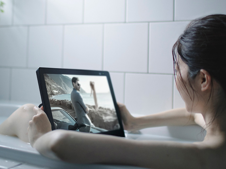 写真：入浴しながらポータブルテレビ使用している様子