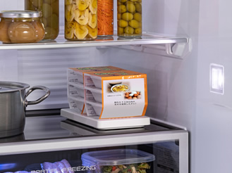 冷蔵庫内に置いた重量検知プレートの上に、納豆を6パック載せている画像です。