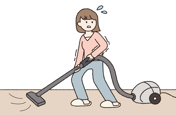 掃除機を重そうに抱えて掃除している女性のイラストです。