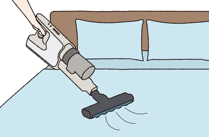 ベッドの上に掃除機をかけているイラストです。