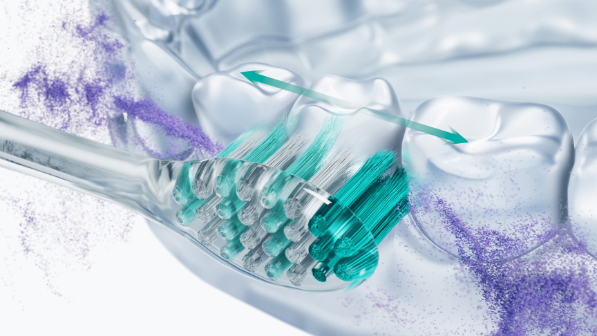 歯を横方向に磨く歯ブラシのクローズアップ
