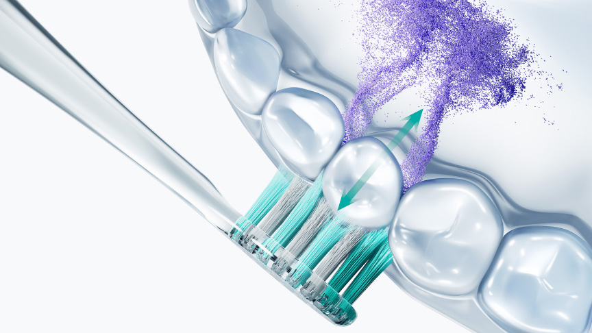 歯を磨く歯ブラシとブラッシング方向の矢印