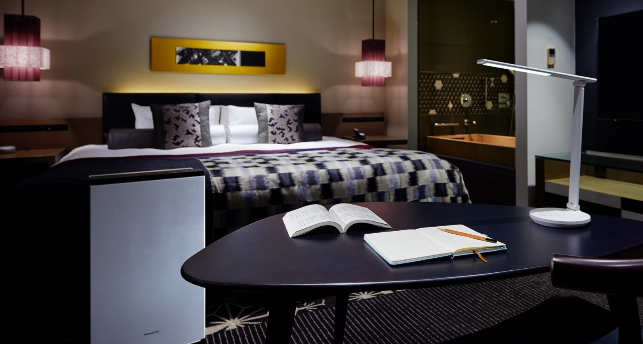 受験生プランPremiumのメインビジュアルです。ホテルの室内にジアイーノとLEDデスクスタンドが設置してあります。